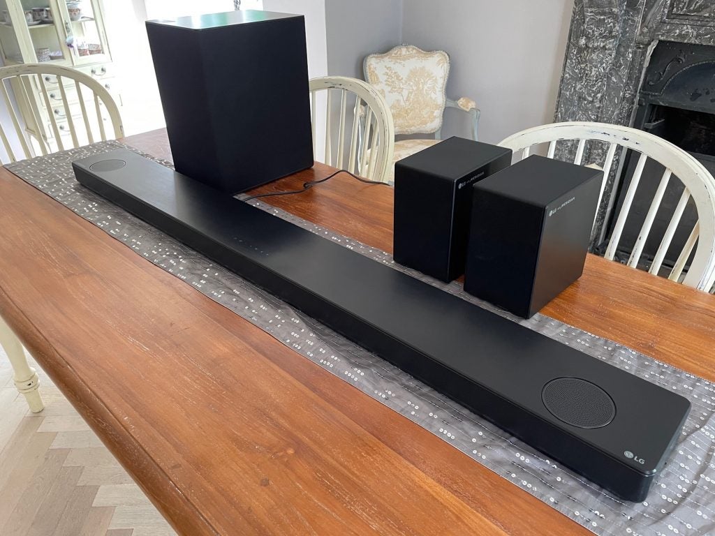 All four components of the LG SP11RA soundbar package.