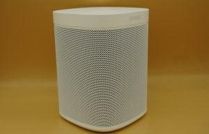 A white Sonos One SL speaker standing on a table